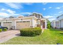 Tan two-story house with two-car garage and neatly landscaped yard at 2507 Yellow Brick Rd, St Cloud, FL 34772