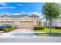Well-kept townhome with a two-car garage and tidy landscaping for great curb appeal at 2507 Yellow Brick Rd, St Cloud, FL 34772