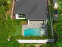 Aerial view of home and backyard pool with privacy fence and mature landscaping at 2510 Amherst Ave, Orlando, FL 32804