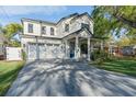 A beautiful two-story home with a two-car garage and a modern blue front door, complemented by an attractive stone driveway at 2510 Amherst Ave, Orlando, FL 32804