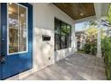 Covered front porch with pavers, a blue door, and a side window at 2510 Amherst Ave, Orlando, FL 32804