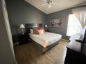 Spacious bedroom with light wood floors and a ceiling fan at 2564 Bear Creek Ct, Kissimmee, FL 34747