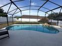 Inviting kidney-shaped pool with a screened enclosure at 2564 Bear Creek Ct, Kissimmee, FL 34747