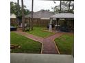 Brick-paved backyard with gazebo and multiple sitting areas at 2950 Omaha Dr, Deltona, FL 32738