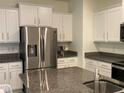 Modern kitchen with stainless steel appliances and granite countertops at 3384 Yellowtop Loop, Clermont, FL 34714