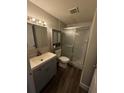 Well-lit bathroom featuring a vanity with storage and a glass-enclosed shower with tile surround at 359 Prevo Dr, Apopka, FL 32712