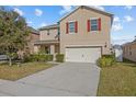 Two-story house with a two-car garage and landscaped lawn at 3666 Maidencain St, Clermont, FL 34714