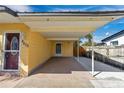 Attached carport and walkway of a single story house with siding and front entrance door at 4806 Hollyberry Dr, Orlando, FL 32812