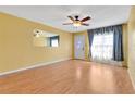 Spacious living room featuring laminate floors and ceiling fan at 4806 Hollyberry Dr, Orlando, FL 32812