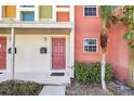 Condo building entrance with colorful facade and landscaping at 4952 Tangerine Ave # 4952, Winter Park, FL 32792