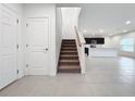 Modern staircase with carpet runner, leading to upper level at 5627 Costa Blanca Way, Davenport, FL 33897