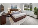 Bright bedroom with a king-size bed, large window, and wall-mounted TV at 644 Maya Susan Loop, Apopka, FL 32712