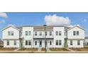 Three-unit townhome building with modern design, landscaping, and a light color scheme at 6581 Quest St, St Cloud, FL 34771