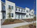 Three story townhome with light gray accents at 6581 Quest St, St Cloud, FL 34771