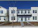 Modern townhome with white and gray exterior at 6581 Quest St, St Cloud, FL 34771