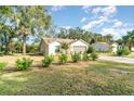 Charming single-story house with a spacious front yard and mature trees at 701 Grant Ave, Mount Dora, FL 32757