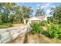 Well-maintained house with a driveway, two-car garage, and lush green landscaping at 701 Grant Ave, Mount Dora, FL 32757