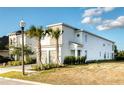 Two-story house with attached garage and palm trees at 801 Golden Bear Dr, Kissimmee, FL 34747