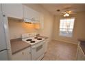 Kitchen with white appliances and cabinets at 832 Grand Regency Pt # 102, Altamonte Springs, FL 32714