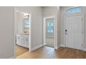 Bright entryway with tile flooring, powder room, and views to the living room at 9693 Lost Creek Dr, Winter Garden, FL 34787