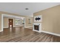 Open living room with wood-look floors and a view into another room at 107 Japonica Dr, Orlando, FL 32807