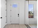 Bright and airy entryway with white door and tile floor at 15100 Grove Lake Dr, Winter Garden, FL 34787