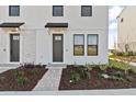 Modern townhome with gray front door and brick facade at 15100 Grove Lake Dr, Winter Garden, FL 34787