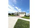 One-story house with a two-car garage and a nicely landscaped front yard at 17795 Blazing Star Cir, Clermont, FL 34714