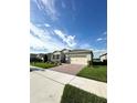 One-story house with a two-car garage and a nicely landscaped front yard at 17795 Blazing Star Cir, Clermont, FL 34714