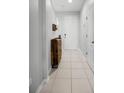 Light and airy foyer with tile flooring and a wooden storage bench at 2909 Econ Landing Blvd, Orlando, FL 32825