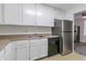 Kitchen with white cabinets and stainless steel appliances at 4017 Versailles Dr # 4017F, Orlando, FL 32808
