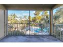 Screened balcony overlooking pool and trees at 4017 Versailles Dr # 4017F, Orlando, FL 32808