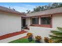 Inviting front entry featuring a colorful landscaped garden at 654 Boniview Ln, Altamonte Springs, FL 32714