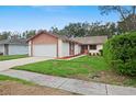 A well kept front yard with trimmed hedges and mature trees at 654 Boniview Ln, Altamonte Springs, FL 32714