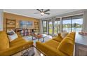Living room with two mustard yellow sofas and lake view at 670 Lake Villas Dr # D, Altamonte Springs, FL 32701