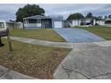 House exterior showcasing a driveway and landscaping at 6845 Pompeii Rd, Orlando, FL 32822