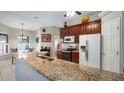 Spacious kitchen with granite countertops and modern appliances at 8835 Spyglass Loop, Clermont, FL 34711