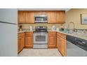 Well-equipped kitchen featuring granite countertops and stainless steel appliances at 1007 Baseball And Boardwalk Ct, Kissimmee, FL 34746