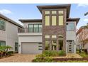 Modern home with stone accents and a three-car garage at 1038 Jack Nicklaus Ct, Kissimmee, FL 34747