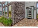 Modern front entrance with stone facade and glass door at 1038 Jack Nicklaus Ct, Kissimmee, FL 34747