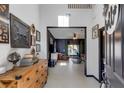 Bright and spacious entryway with rustic wooden furniture and gallery wall at 1101 Atlantic Ave, Fruitland Park, FL 34731