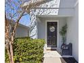 Inviting front entry with a dark door, Hello sign, and potted plant at 1101 Atlantic Ave, Fruitland Park, FL 34731