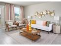 Living room with white sofa, wooden coffee table and stylish decor at 1341 Current Pl, Haines City, FL 33844