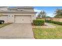 Attached garage with a paved driveway and landscaping at 13805 Bressler Aly, Windermere, FL 34786