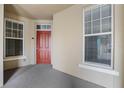 Inviting condo entryway with red door and neutral walls at 1410 Celebration Ave # 101, Celebration, FL 34747