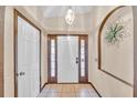 Bright and airy entryway with tiled floors and decorative wall art at 2041 Black Hawk St, Clermont, FL 34714