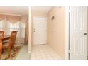 Home entryway with tiled floor, adjacent dining room, and interior door at 214 Covent Garden Ave, Davenport, FL 33897