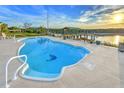 Enjoy this kidney-shaped pool with mosaic detail, fenced-in for safety, with a dock and lovely sunset views at 218 S Venetian Way, Port Orange, FL 32127