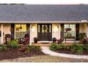 Inviting front porch with rocking chairs and landscaping at 2501 Jennifer Hope Blvd, Longwood, FL 32779