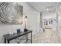 Bright entryway with stylish flooring, table with lamp and artwork on the wall at 2628 Calistoga Ave, Kissimmee, FL 34741